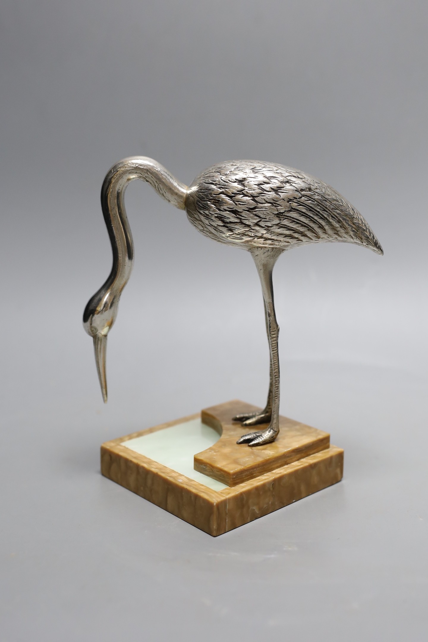 An Art Deco silvered bronze model of a crane, on an onyx base, 18cm